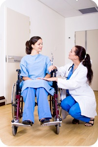 Doctor talking to patient in wheelchair.